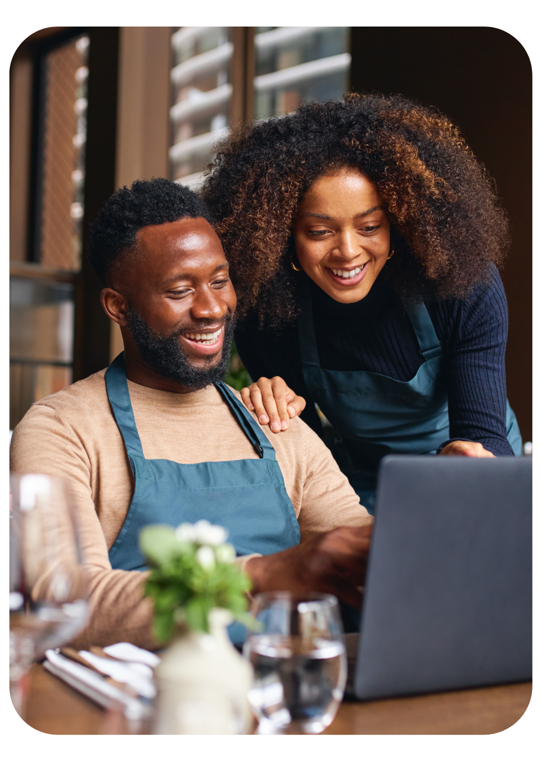 waitress and waiter looking at computer